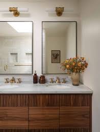 The bathroom is a space where you can truly escape from the stress of a busy day, whether it's just for a moment or two or for hours when you're soaking in the tub. Heidi Caillier Design Seattle Interior Designer Olympic Manor House Modern Traditional Master Bathroom Custom Wood Vanity Brass Faucets Mid Century Home Heidi Caillier