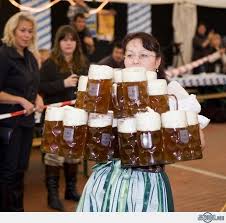 Oktoberfest Waitress Serves Mugs Of Beer Oktoberfest Octoberfest Beer Drinking Beer