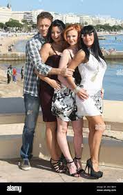 Italian actor, producer, director, Rocco Siffredi poses for photographers  with the new Dorcel Girls, left to right, Anna Polina, Tara White and Jade  Laroche, during the MIPTV (International Television Programme Market),  Tuesday,