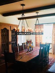 A graphite plate accents the top of the structure as thin metal bars anchor the rustic light fixture to the ceiling. Handmade Iron Lighting Fixtures Illuminaries Lighting Iron Lighting Fixtures Iron Lighting Wrought Iron Lights