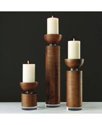Just grab a larger than average log, saw it down the middle, and drill some tea light pockets on the inside for a rustic candle holder that's comparable to the look of a small fireplace. Global Views Scratched Pillar Candleholder Large Brown Wood Candle Holders Wood Turned Candle Holders Candle Holders
