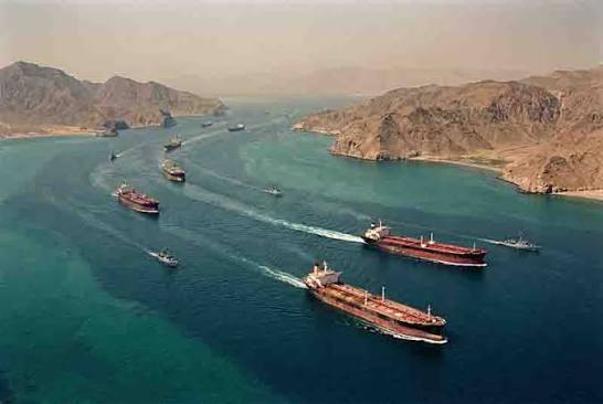 A tanker ship navigating through the narrow and strategic Strait of Hormuz waters.