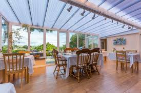 A dining room and hall appear on the ground floor, and the upper floors presumably contain some bedrooms at least. Old Coach House Conservatory Dining Room The Old Coach House Boscastle