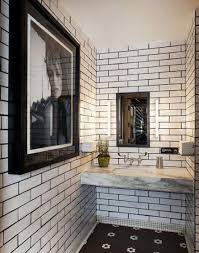 Black And White Restaurant Floor Tiles Restaurant Bathroom With Dark Grouted White Subway Tile And A Black And White Hex Tile Floor White Bathroom Designs White Subway Tiles Bathroom Inspiration