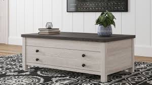 This pleasant coffee table has a fully extending top that is both a snug computer workstation and ideal for dining. The Dorrinson Two Tone Rect Lift Top Cocktail Table Available At Furniture Connection Serving Clarksville Tennessee And Ft Campbell Kentucky