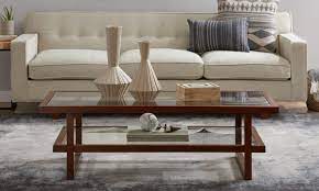 A glass coffee table makes for an elegant, subtle addition to the room, while a coffee table with storage is perfect for creating space for a striking centerpiece. 4 Tips For Styling A Two Tier Coffee Table Overstock Com