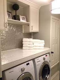 Maybe you would like to learn more about one of these? Comfortable Yet Modern Style Utility Laundry Room With Stainless Backsplash Tiles And White Cabinets Compact Laundry Room Laundry Room Remodel Laundry Room