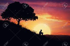 All images for free even for commercial use. Boy Sit Alone On A Hill In The Center Of Nature Over A Sunset Background Standing Away From The Crowd Waiting For The Healing Power Of The Nature Stock Photo Picture And