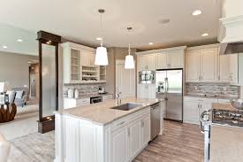 An open living area with vaulted ceilings and fireplace. Cabinets Galore Decor Cabinets Ltd
