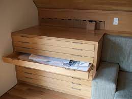 This ikea kallax hack, with 5 individual flat file drawers and one large drawer with faux drawer fronts, is a genius (and beautiful!) way to store arts and craft supplies. Illustration Of How To Transform Busy Home Office With Flat File Cabinet Ikea Attic Storage Attic Renovation Attic Design