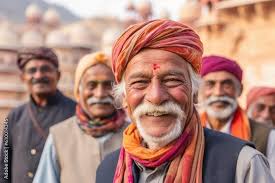 Poster, Print Lifestyle portrait photography of a tender man in his 60s  that is smiling with friends at the Amber Fort in Jaipur India, 40x26.7 cm