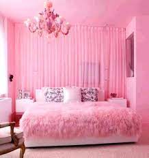 Lovely black and pink girl's bedroom is lit by a regina andrew malibu chandelier hung from a vaulted plank ceiling over a pink rug placed beneath a black velvet french bed. Girls Pink Bedroom Ideas Design Corral