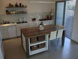 The spacious countertop extends past the island base to accommodate two backless saddle seat counter height stools. What Is A Under The Counter Microwave And How To Utilize It In The Kitchen Kitchen Island Dining Table Portable Kitchen Island Kitchen Island And Table Combo