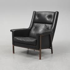 Canterburry black bonded leather high back wing chair. A Second Half Of The 20th Century Easy Chair With Copper Legs And Black Leather Upholstery Bukowskis