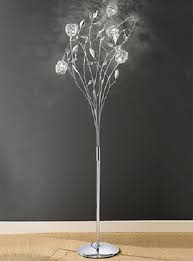 The glass base rendered in a white glass with gold glitter finish brings a hint of color to any space. Sparkle Floor Lamp Online