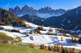 The Small Village Of St. Magdalena Or Santa Maddalena With Its Church  Covered In Snow And With The Odle Or Geisler Dolomites Mountains In The Val  Di Funes Valley, South Tyrol, Italy