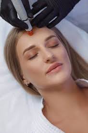 Cosmetologist performing a facial cleansing procedure