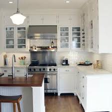 This gray and white family kitchen has touches of gold and warm accents. Cabinets With Exposed Hinges Design Ideas