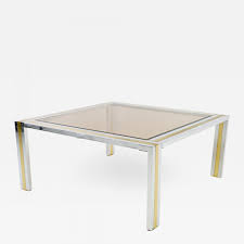 Even though the two may occupy exactly the same footprint, the wood table will have a bigger presence in the room and seem to take up more floor space. Renato Zevi Renato Zevi Italian Mid Century Chrome Brass And Glass Coffee Table