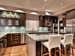 This modern open concept kitchen is alluring with its large veneer cabinetry contrasting against beige granite countertops and tile flooring. Open Concept Modern Kitchen Shirry Dolgin Hgtv