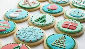 Christmas cookies with baking utensils, ingredients and cookie cutters on a rustic wood background from above. 10 Ways To Decorate Your Christmas Cookies Like A Pro Brit Co