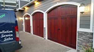 Automatic garage door opener motor on the ceiling. How To Care For A Wood Garage Door In The Pacific Northwest Distribudoors