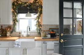 This display creates a snowy, winter scene, using a silver wreath and various white, glass and silver xmas objects and back lighting. Christmas In Our Small Kitchen Started With Christmas Garland Nesting With Grace