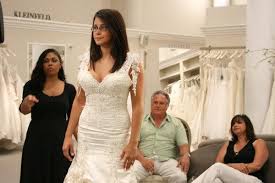 The skirt is a mixture of different ruffle styles and roses. How To Help Shop For A Wedding Dress
