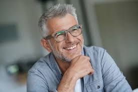 Smiling woman wearing spectacles portrait of beautiful mature woman sitting in cafeteria looking away. Deafblind Uk Helps People To Live Better With Sight And Hearing Loss This Deafblind Awareness Week Deafblind Uk