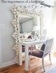 A shallow wood cabinet was customized with a piece of framed artwork and hung over the vanity table to create a place to stash makeup and hair products. The Importance Of A Bedroom Vanity Area Ashlina Kaposta