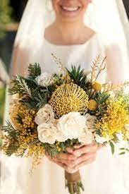 It's a great way to give. Australia Natives Wedding Bouquet Featuring Yellow Pin Cushion Protea Yellow Mimosa Flower Yellow Craspedia White Tea Roses Flower Bouquet Wedding Yellow Wedding Flowers Fall Wedding Bouquets
