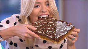 Holly Willoughby reveals she's recovered from her NTAs hangover as she  wears £550 spotted silk top for This Morning