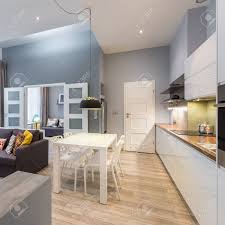 In this 80 m2 located on the 6th floor of a parisian building, the kitchen has been completely redesigned, so that it opens onto the dining room. Contemporary Apartment With Dining Table Open Kitchen And Living Room Stock Photo Picture And Royalty Free Image Image 93544670