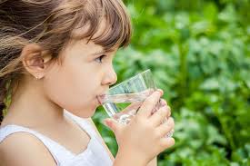 Portrait of a cute little boy drinking a glass of water portrait of a cute little boy drinking a glass of water. Tips To Help Your Child Drink More Water Mountain Fresh
