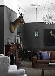 Interior designer, suzanne dimma shows us a design that is more on the masculine side. Masculine Decor Feminine Crystal Chandelier Beautiful Contrast Trendy Living Rooms Dark Grey Walls