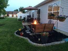 Low Cost Patio Extension Using Mulch Paver Steps And Concrete Edgers Featuring A Fire Table From Lowe S Patio Extension Ideas Backyard Backyard Patio