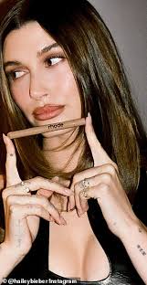 Justin Bieber lurks behind wife Hailey as they leave her Rhode launch party  amid concerns for his well-being