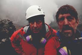 Ken Sims &#39;86 and John Catto &#39;82 stand near the mouth of Africa&#39;s most active volcano, Mt. Nyiragongo, in the Democratic Republic of the Congo in July 2010. - 23b
