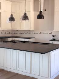 White glossy cabinets with a simple and straightforward geometry are best combined with a black granite countertop. Ask Maria Help My White Kitchen Cabinets Seem To Change Colour