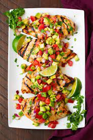 In a glass bowl, combine 1/4 cup of lime juice, 3 tbsp of the coriander, 2 tbsp of the olive oil, garlic and half each of the salt and pepper. Cilantro Lime Chicken With Avocado Salsa Cooking Classy