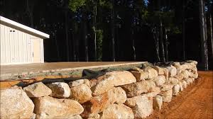 The standard design for a gabion wall is a pyramid. Building A Rock Retaining Wall Youtube
