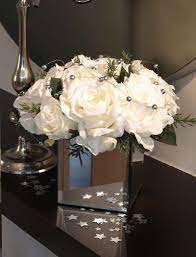 Artificial flowers, a bouquet in a vase on a white background. Roses And Silver Balls In Mirrored Vase Rtfact Artificial Silk Flowers Artificial Silk Flowers Wedding Flower Arrangements Silk Flowers