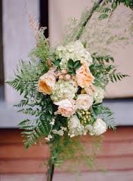Here with this miserable heat everything burns especially since we are still restricted on water use it is not a good thing to try to grow flower. Fern And Peach Rose Wedding Arch Arrangement