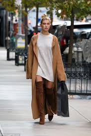 This white turtleneck sweater is warm and stylish. Hailey Baldwin Wears Over The Knee Suede Boots And A Flowing Camel Coat In New York Daily Mail Online