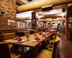 A Restaurant Hall With Red Brick Walls Wooden Tables And Pipes In The Ceiling Paid Affiliate Sponsored Red In 2020 Red Brick Walls Wooden Tables Brick Wall
