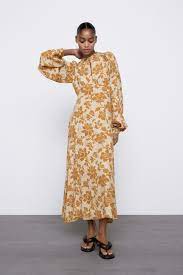 The dress have two pockets on the size of the dress and her length is Floral Print Midi Dress Zara Thailand