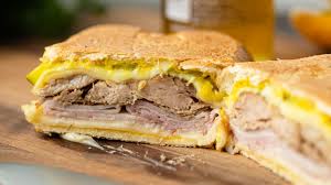 A cuban sandwich is a variation of a ham and cheese sandwich that likely originated in cafes catering to cuban workers in tampa or key west, two early cuban immigrant communities in florida centered around the cigar industry. Cuban Sandwich Recipe Video Kevin Is Cooking