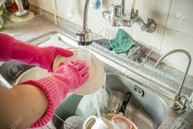 hand washing dishes in sink after meal