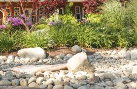 Using river rocks when landscaping is no different from using ocean rocks; Landscaping With River Rock Dry River Rock Garden Ideas The Happy Housie