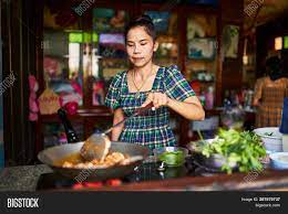 Woman cooking and presenting at kitchen. Thai Mother Cooking Image Photo Free Trial Bigstock